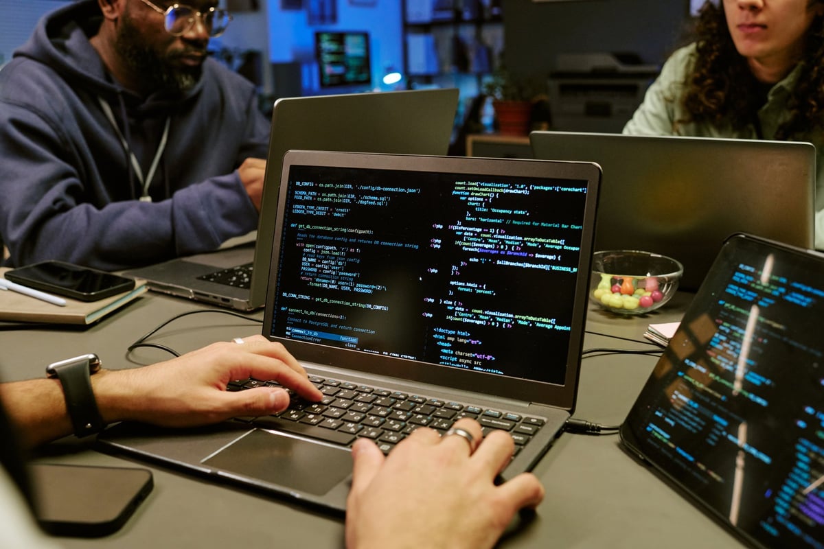 Software development team collaborating on programming code